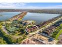 Stunning aerial view of a lakeside community with access to a pool, tennis court and other amenities at 108 Maraviya Blvd, Nokomis, FL 34275