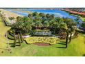 Beautiful entrance to Toscana Isles community with lush landscaping and stunning lake views at 108 Maraviya Blvd, Nokomis, FL 34275