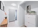 Bright entryway with modern décor, stylish console table, and contemporary artwork on display at 128 Da Vinci Dr, Nokomis, FL 34275