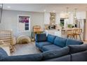 Open-concept living space blending a stylish living room and a modern kitchen with breakfast bar seating at 1305 20Th W St, Bradenton, FL 34205