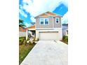 Inviting two-story home showcasing a modern design, two-car garage and well-maintained landscaping at 13068 Oak Hill Way, Parrish, FL 34219