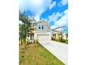 Charming two-story home with a two-car garage, complimented by a lush green lawn and mature landscaping at 13068 Oak Hill Way, Parrish, FL 34219