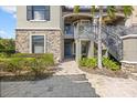 Inviting exterior of a home with a stone facade and well-maintained landscaping at 13711 Messina Loop # 101, Bradenton, FL 34211