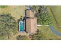 Aerial view of a home with a private pool and a long driveway surrounded by trees at 1450 & 12001 Bern Creek Loop, Sarasota, FL 34240