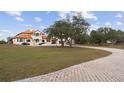 Stunning home with a long driveway, lush lawn, and a bright orange tile roof at 1450 & 12001 Bern Creek Loop, Sarasota, FL 34240