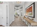 Hallway with art, console table, and view into main living area at 14817 Secret Harbor Pl, Lakewood Ranch, FL 34202