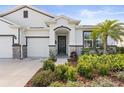 Inviting front entrance with stone accents, a well-maintained yard, and colorful landscaping at 17108 Harvest Moon Way, Bradenton, FL 34211