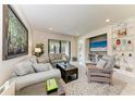 Cozy living room featuring comfortable sofas, stylish decor, and sliding glass doors to the outdoor patio at 17696 Northwood Pl, Lakewood Ranch, FL 34202