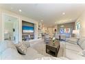 Spacious living room with neutral tones, built-in shelving, and an open concept design to the dining area at 17696 Northwood Pl, Lakewood Ranch, FL 34202