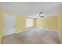 Bright living room with terrazzo floors, ceiling fan and neutral wall color at 18348 Yale Ave, Port Charlotte, FL 33948