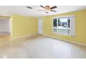 Open-concept living area with large window, light walls, and terrazzo floors at 18348 Yale Ave, Port Charlotte, FL 33948