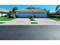A well-maintained home with a tile roof, two-car garage, and tidy front yard at 321 Reclinata Cir, Venice, FL 34292
