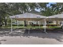 Assigned parking spot with awning in front of condo building at 3702 54Th W Dr # 103, Bradenton, FL 34210