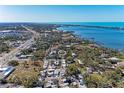 Gorgeous aerial view of neighborhood featuring beautiful waterfront views and lush landscapes under clear blue skies at 51 Webb St, Osprey, FL 34229