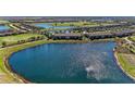 Panoramic aerial view showcasing the property, lake, and community golf course at 5577 Palmer Cir # 203, Bradenton, FL 34211