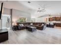 Inviting living room with modern gray walls and flooring that opens up to the beautiful kitchen at 5757 Jonesboro Ave, North Port, FL 34288