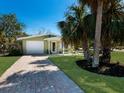 Charming home with attached garage and a brick paver driveway and walkway at 640 Fox St, Longboat Key, FL 34228