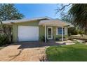 Charming home with attached garage, quaint front porch and freshly manicured lawn at 640 Fox St, Longboat Key, FL 34228