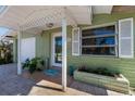 Inviting front entrance featuring a cozy porch and colorful plants at 640 Fox St, Longboat Key, FL 34228