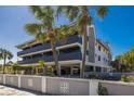 Exterior view of condo building with a sign, showing multiple stories, balconies, and under-building parking at 6804 Gulf Dr # 6804, Holmes Beach, FL 34217