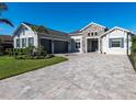 Charming home with stone accents, three-car garage, and paver driveway at 7095 Tamworth Pkwy, Sarasota, FL 34241