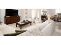 Bright living room with modern furniture, recessed lighting, and neutral decor at 7095 Tamworth Pkwy, Sarasota, FL 34241