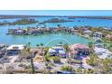 Stunning waterfront home with private dock and boat lift, surrounded by lush landscaping and turquoise waters at 810 Siesta Dr, Sarasota, FL 34242