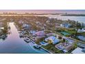 Waterfront estate featuring a pool, boat dock, and meticulously maintained grounds, offering luxurious coastal living at 810 Siesta Dr, Sarasota, FL 34242