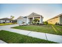 Lovely single-story home featuring lush landscaping and a well-maintained green lawn at 11021 Moonsail Dr, Parrish, FL 34219