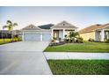 Beautiful single-story home with well-maintained lawn, mature palm trees, and a spacious driveway at 11021 Moonsail Dr, Parrish, FL 34219