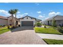 Charming single-story home with a tile roof, brick paver driveway, and well-maintained landscaping at 11522 Trivio Ter, Palmetto, FL 34221