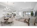 Bright, open-concept living and dining area featuring modern lighting and neutral decor at 11522 Trivio Ter, Palmetto, FL 34221