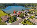 Beautiful waterfront property with stunning lake views, lush landscaping, screened lanai, and a private in-ground pool at 12420 Aster Ave, Bradenton, FL 34212