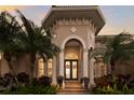 Elegant home entryway with a double door, decorative columns, and manicured landscaping at 13635 Legends Walk Ter, Lakewood Ranch, FL 34202