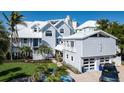 Charming exterior view of home with a gabled roof, lush landscaping, and inviting facade at 137 Big Pass Ln, Sarasota, FL 34242