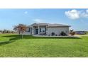 Inviting single-story home with a spacious green lawn and elegant, neutral exterior paint at 13904 Gettis Lee Rd, Parrish, FL 34219