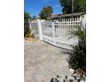 Exterior shot of a home's white picket fence with a paver pathway at 1534 25Th St, Sarasota, FL 34234