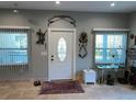 Light-filled foyer featuring tile floors, decorative accents, and a stylish front door at 1534 25Th St, Sarasota, FL 34234