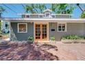 Charming home featuring a brick walkway, stylish planters, and unique architectural details at 1739 Oak St, Sarasota, FL 34236