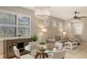 Bright dining area with a glass-top table, stylish chairs, and views of the living room, perfect for entertaining at 17440 Hampton Falls Ter, Bradenton, FL 34202
