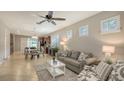 Open-concept living room with tile flooring, a comfortable sofa, and views of the kitchen and dining area at 17440 Hampton Falls Ter, Bradenton, FL 34202
