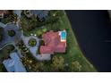 An aerial view of this home shows a pool, lush landscaping, a circular driveway, and a tile roof at 1819 97Th Nw St, Bradenton, FL 34209