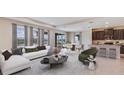 Stylishly furnished open-concept living room flowing into the dining area and kitchen with lovely views at 18312 Thistleberry Pl, Lakewood Ranch, FL 34211