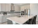 Kitchen boasts stainless steel appliances, quartz countertops, and a stylish backsplash at 2015 Bolsena St, Nokomis, FL 34275