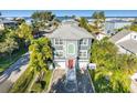 Beautiful two-story home with a brick driveway, palm trees and a view of the ocean at 2300 Avenue B, Bradenton Beach, FL 34217