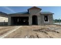 New construction single-story home featuring block construction, an attached two-car garage, and a covered entry at 278 Hillshire Pl, Spring Hill, FL 34609