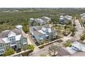 Expansive aerial shot of a beautiful home with a metal roof and a perfectly manicured lawn at 315 Sapphire Lake Dr # 202, Bradenton, FL 34209