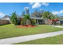 Inviting single-story home with a lush lawn and well-manicured landscaping, offering great curb appeal at 3458 Lalani Blvd, Sarasota, FL 34232