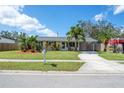 Inviting single-story home with a lush lawn and well-manicured landscaping, offering great curb appeal at 3458 Lalani Blvd, Sarasota, FL 34232