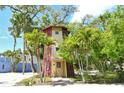 Unique two-story cottage surrounded by lush tropical foliage in a serene setting at 433 N Osprey Ave, Sarasota, FL 34236